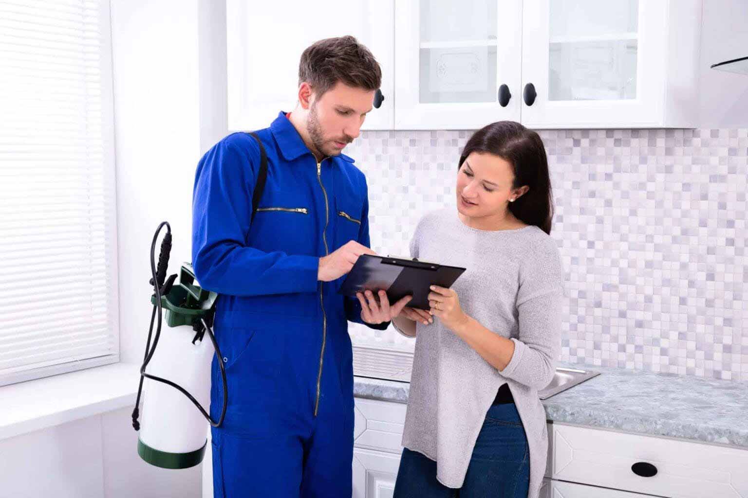 Pest-Control-Worker-Showing-Invoice-Woman Pest control worker showing a list