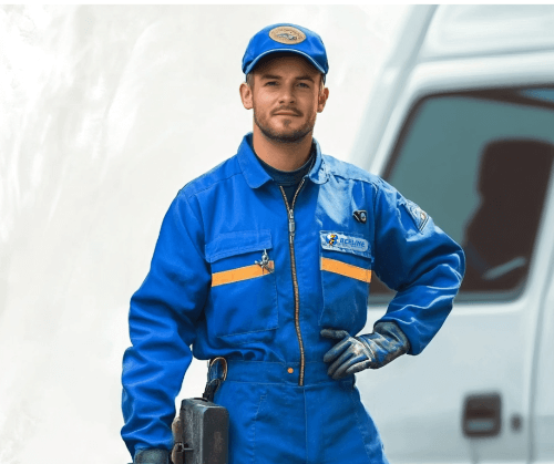 Exterminators Professional pest control exterminator in a blue Beeline uniform standing in front of a service van.