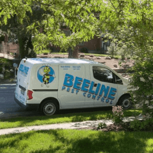 Beeline Pest Control service van parked on a residential street for a local home treatment.