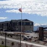 A residential complex with a backdrop of stunning snow-capped mountains.